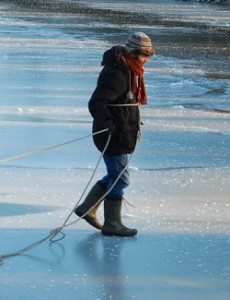 man walking across frozen lake
